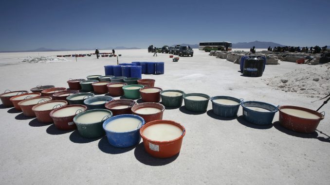 Containers of brine to extract lithium are seen at the Uyuni salt lake