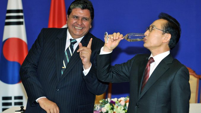 South Korea's President Lee drinks champagne as his Peruvian counterpart Garcia gestures after a signing ceremony at the presidential Blue House in Seoul