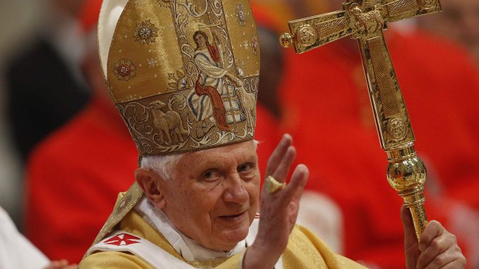 Pope Benedict XVI waves as he arrives to celebrate a mass in Saint Peter's Basilica at the Vatican