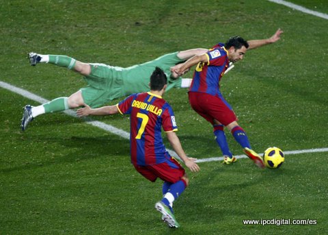 Barcelona's Xavi scores a goal past Real Madrid's goalkeeper Casillas during their Spanish first division soccer match in Barcelona