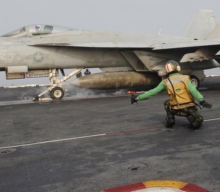 A U.S. Navy F/A-18F Super Hornet takes off from the USS George Washington aircraft carrier in the West Sea