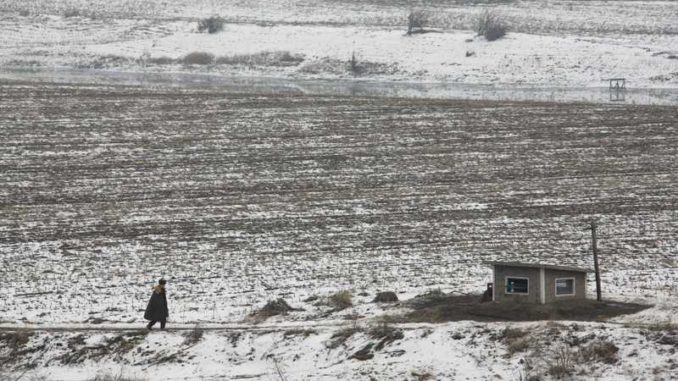 A North Korean soldier walks on an island located in the middle of the Yalu River, near the North Korean town of Sinuiju and the Chinese border city of Dandong