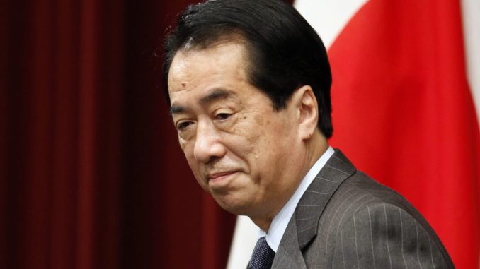 Japanese Prime Minister Naoto Kan arrives at a news conference in Tokyo