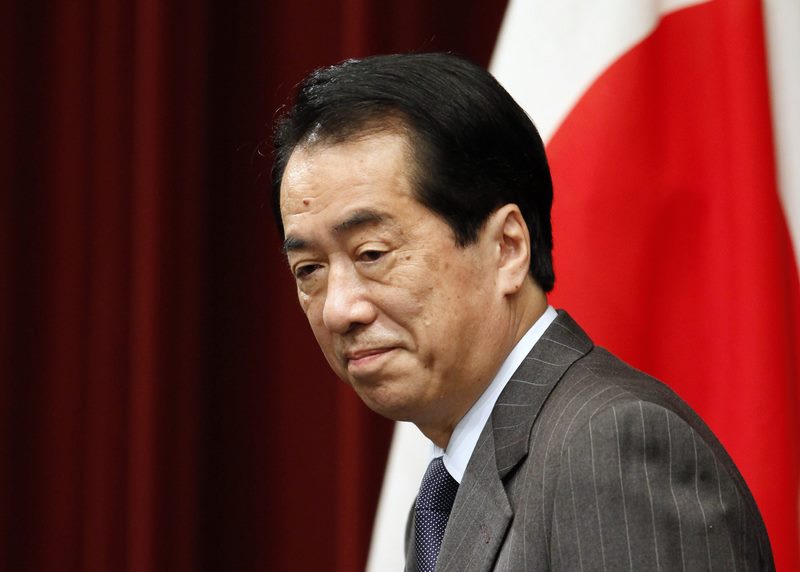 Japanese Prime Minister Naoto Kan arrives at a news conference in Tokyo
