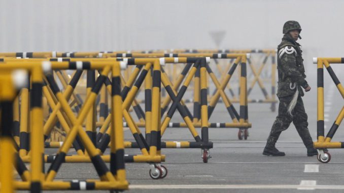 A South Korean Army soldier stands guard beside barricades in front of Tongil Bridge near the demilitarised zone separating the two Koreas in Paju