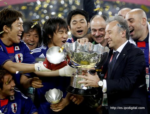 Japan's coach Alberto Zaccheroni of Italy receives the Asian Cup trophy from his players after their 2011 Asian Cup final soccer match win against Australia at Khalifa stadium in Doha