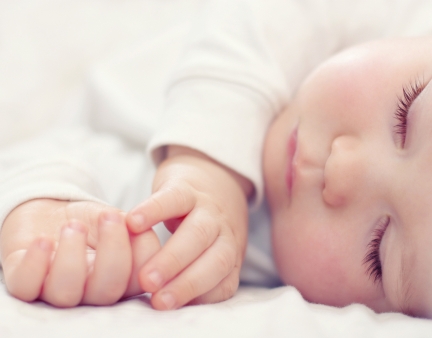 close-up portrait of a beautiful sleeping baby on white