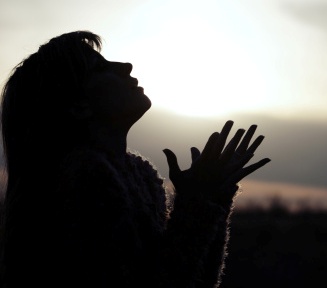 Praying woman in field