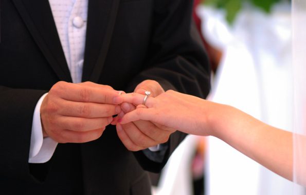 He put the wedding ring on her finger