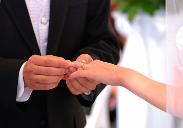 He put the wedding ring on her finger