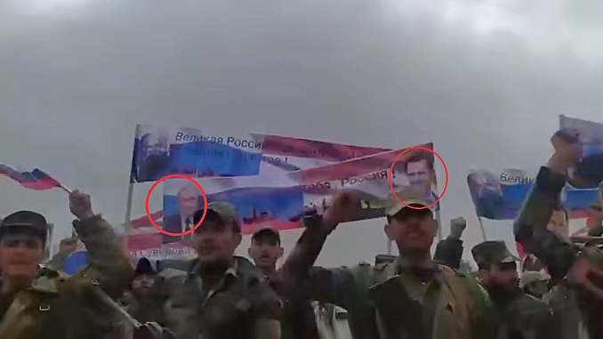 Milicianos sirios con banderolas con la imagen de Putin y el dictador sirio Bashar al-Ásad