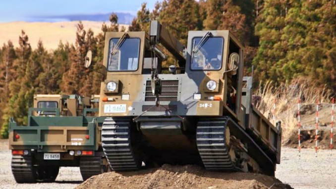 Camiones militares japoneses con orugas para el transporte de material pesado